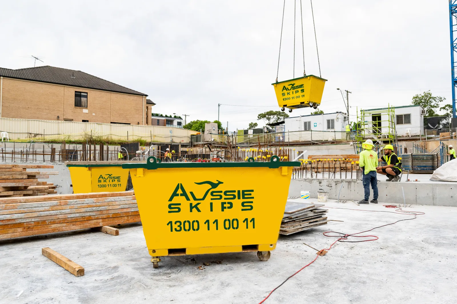 Skip bins being delivered to construction site