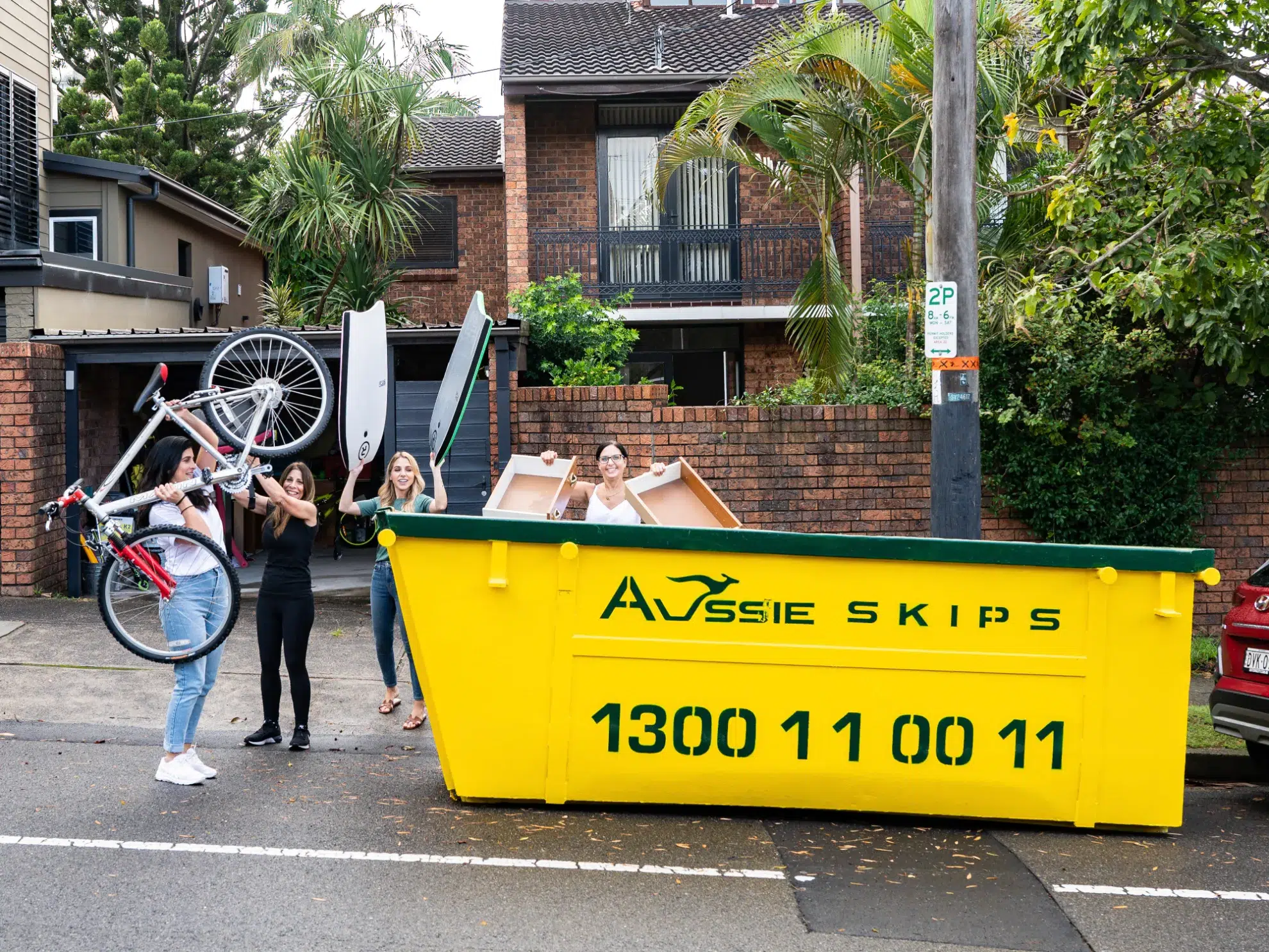 home owners filling up hired skip bin